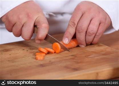 cook cutting carrots