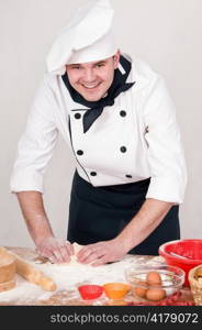 cook kneads the dough for cooking