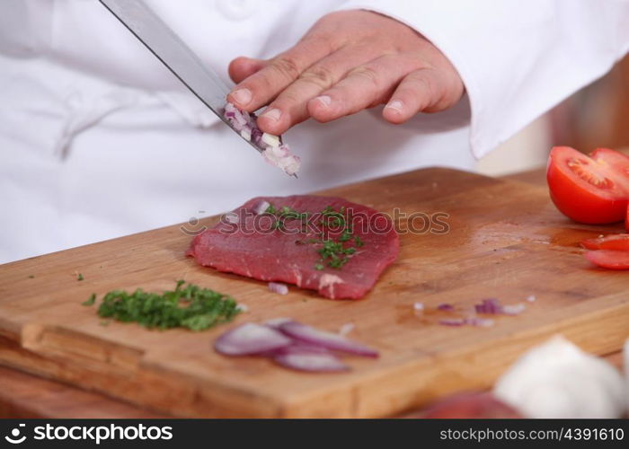 cook preparing steak