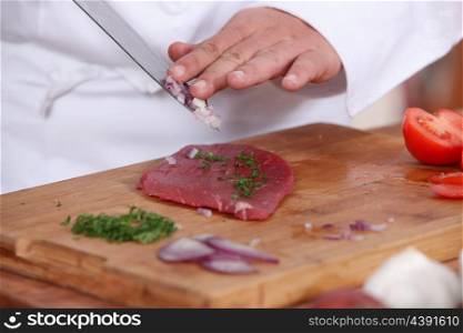 cook preparing steak