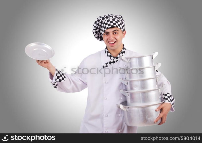 Cook with stack of pots on white