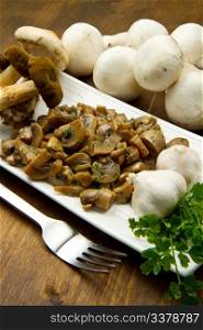 cooked and fresh mushrooms with garlic and parsley