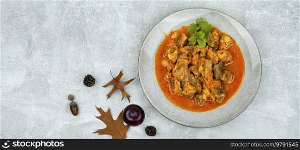 Cooked beef goulash. Meat dish. Recipe with plum gravy. Pasta with meat.Space for text. Appetizing meat goulash, space for text