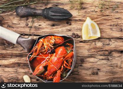 cooked crayfish in metal pan. Cooked crayfish with spices in retro pan