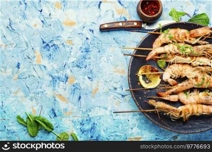 Cooked grilled shrimp on wooden skewers. Space for text. Recipe place. Cooked shrimp, seafood.