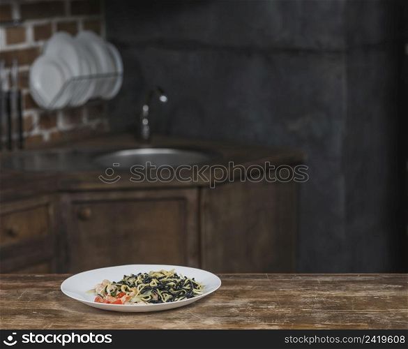 cooked noodles white plate kitchen counter