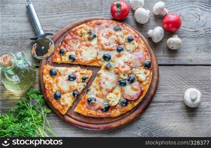 Cooked pizza on the wooden board