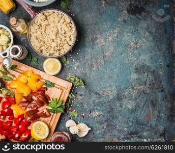 Cooked quinoa in cooking pot with fresh ingredients for salad making on dark rustic background, top view, border. Superfood and healthy Eating concept
