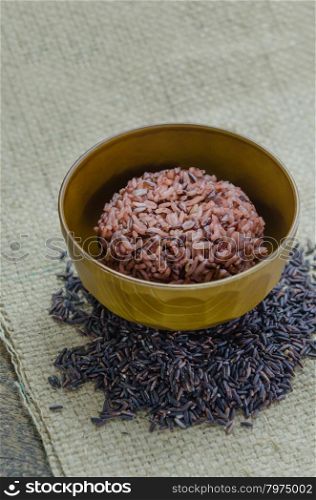 Cooked rice of Riceberry. close up of cooked rice and raw Riceberry