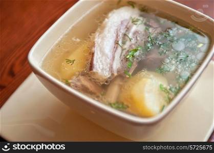 cooked soup with lamb meat, potatoes and vegetables
