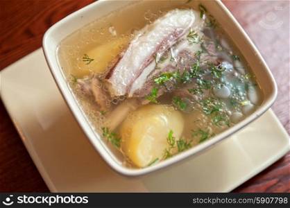 cooked soup with lamb meat, potatoes and vegetables