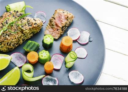 Cooked tuna steak in sesame with vegetables.Fish steak. Grilled tuna steak