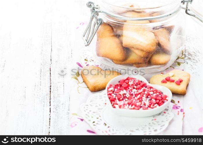 Cookie as a heart shaped valentine decor in glass jar on the table