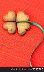 cookie in the form of an Irish clover and green and green on a red background . cookie in the form of an Irish clover and green and green on a red background