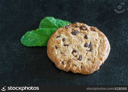 Cookie with chocolate chips and two mint leaves