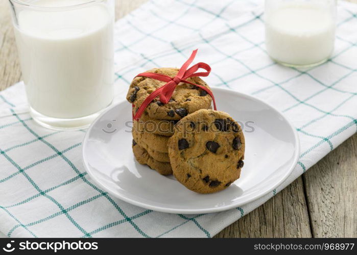 cookies and a glass with milk on wooden table