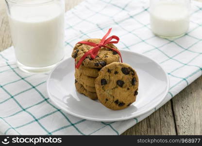 cookies and a glass with milk on wooden table