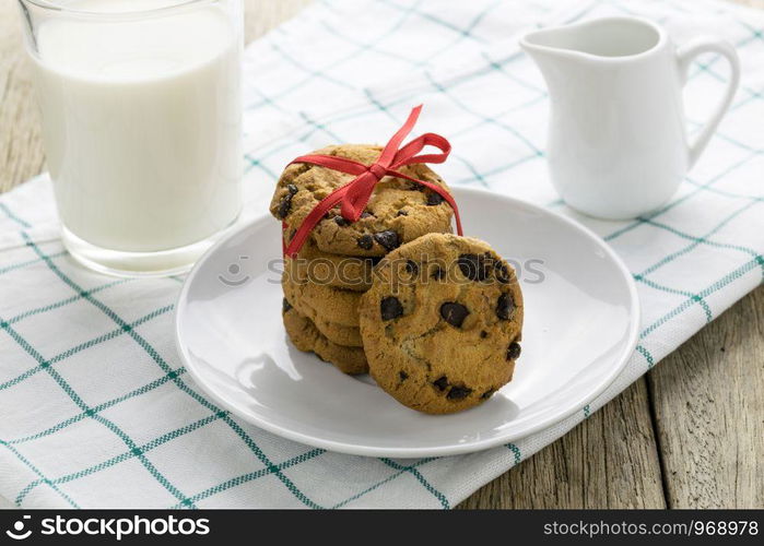 cookies and a glass with milk on wooden table