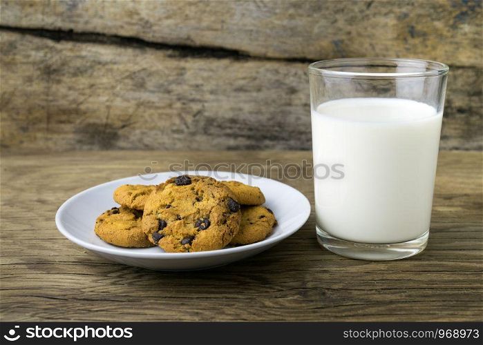 cookies and a glass with milk with a white note for santa