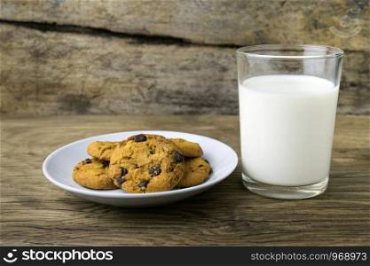 cookies and a glass with milk with a white note for santa