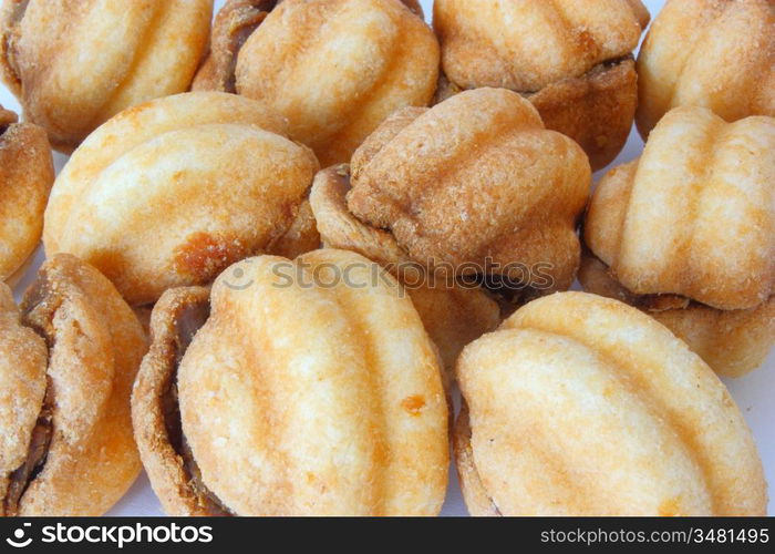 Cookies in the form of walnuts not a white background with a stuffing inside