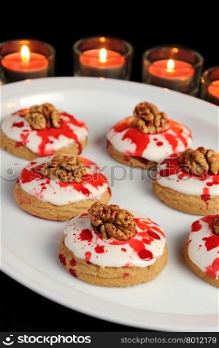 Cookies in white glaze drip blood and walnuts