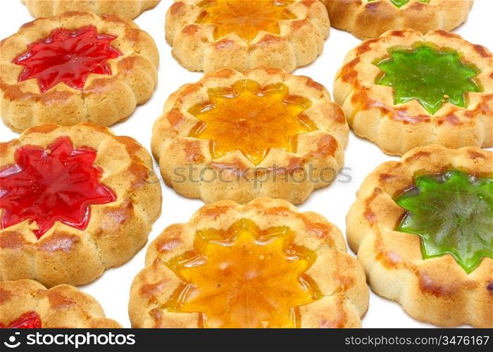 Cookies of yellow color with a stuffing from multi-colored jelly in the middle on a white background