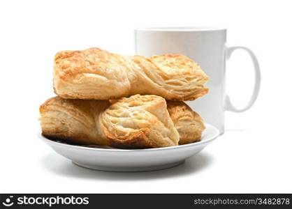 cookies on a plate and cup isolated on a white background