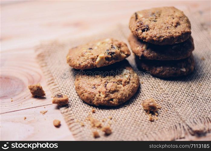 cookies on sack on wooden table , close up
