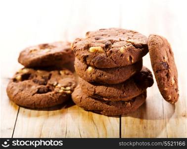 cookies with chocolate and nuts on wooden table