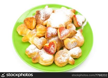 cookies with powdered sugar on a plate isolated on white
