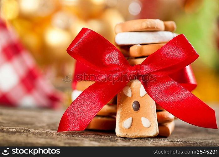 Cookies with red bow against Christmas lights