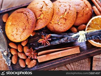 cookies with spice on wooden tray and on a table