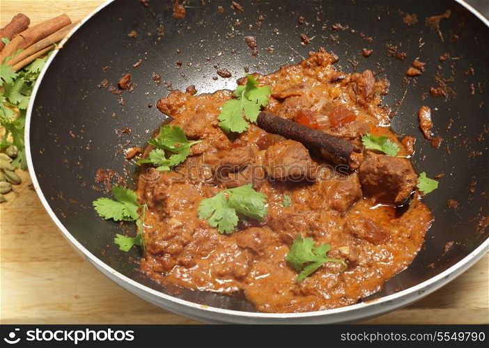 Cooking a balti lamb and yoghurt curry in a wok A tilt-shift lens was used to maximise the depth of field