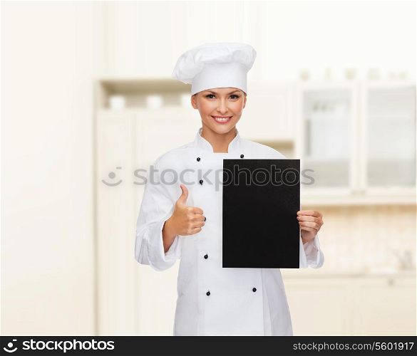 cooking, advertisement and food concept - smiling female chef, cook or baker with blank black paper showing thumbs up