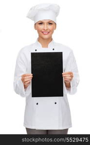 cooking, advertisement and food concept - smiling female chef, cook or baker with blank black paper