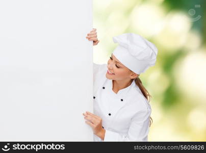 cooking, advertisement and food concept - smiling female chef, cook or baker with white blank board