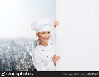 cooking, advertisement and food concept - smiling female chef, cook or baker with white blank board
