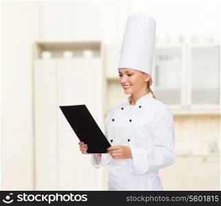 cooking, advertisement and food concept - smiling female chef with blank black paper