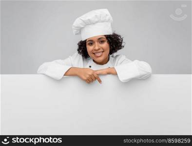 cooking, advertisement and people concept - happy smiling female chef in toque with white board over grey background. smiling female chef with white board
