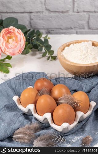 Cooking and baking concept. Baking ingredients on white background. Eggs and flour. Home baking, homemade cooking