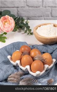Cooking and baking concept. Baking ingredients on white background. Eggs and flour. Home baking, homemade cooking