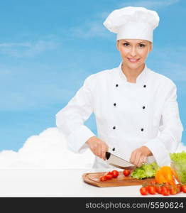 cooking and food concept - smiling female chef, cook or baker chopping vegetables