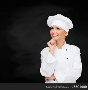 cooking and food concept - smiling female chef, cook or baker dreaming