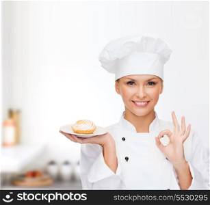 cooking and food concept - smiling female chef, cook or baker with pie on plate and ok sign
