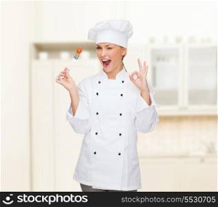 cooking and food concept - smiling female chef, cook or baker with fork and tomato showing ok sign