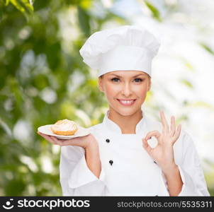 cooking and food concept - smiling female chef, cook or baker with pie on plate and ok sign