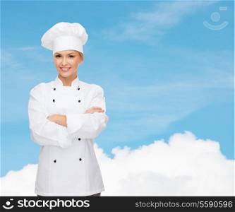 cooking and food concept - smiling female chef, cook or baker with crossed arms