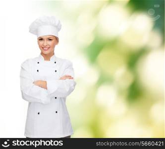cooking and food concept - smiling female chef, cook or baker with crossed arms