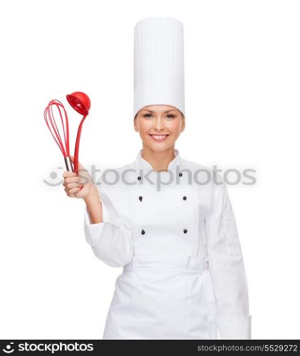 cooking and food concept - smiling female chef with cooking equipment